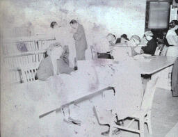 Summer Registration 1961: Blurry Photo of Man and Woman Sitting at Table