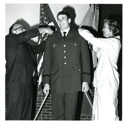 Two Unknown People Pinning Clements' Shoulders (Part of the NMU Historic Photographs Collection)