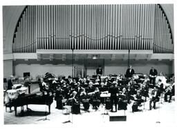 Orchestra Performing on Stage with Organ Pipes behind Them (Part of the NMU Historic Photographs Collection)