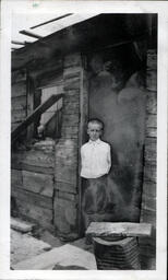 Young Tom Ross with Shaved Head in Doorway