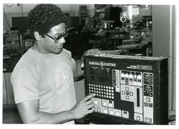 Student Pressing Button on General Electric Mark Century 1050 Controller (Part of the NMU Historic Photographs Collection)