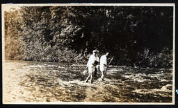 Three Men Standing in River