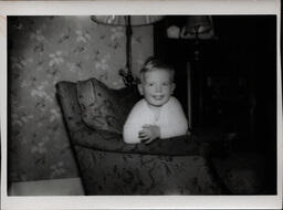 Blond Boy Smiling from Chair