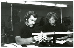 Two Men Looking at Yardstick (Part of the NMU Historic Photographs Collection)