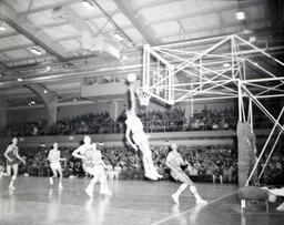 NMC Alumni Basketball 1960-61: Men Playing Basketball View Including Spectators