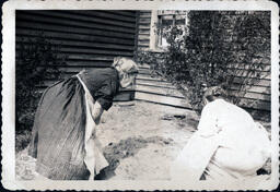 Women Looking at Dirt Plot