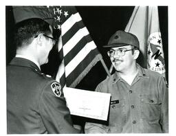 Man in Military Uniform Handing a Piece of Paper to Willis (Part of the NMU Historic Photographs Collection)