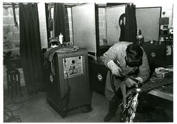 Student Welding in Welding Booth (Part of the NMU Historic Photographs Collection)