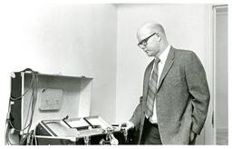 Man Looks at Equipment (Part of the NMU Historic Photographs Collection)