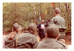 Competitor Running in Woods while Military Members Watch (Part of the NMU Historic Photographs Collection)