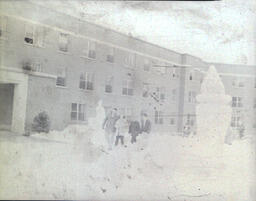 All Events Weekend 1959: Four People Standing by Multiple Snow Sculptures