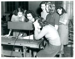 Driving Students Working with Vision Test Equipment Instructor Teaching Students about Engine (Part of the NMU Historic Photographs Collection)