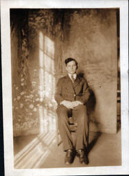 Older Boy with Suit in Front of Photo Backdrop