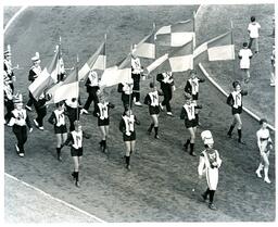 Flag Twirlers and Band Marching onto Dirt Track (Part of the NMU Historic Photographs Collection)