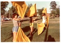 Three Students Twirling Yellow Flags (Part of the NMU Historic Photographs Collection)