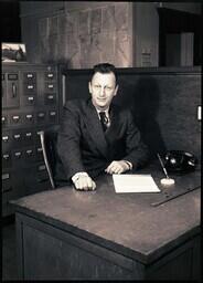 (122-005) Joe Dobbek at Desk