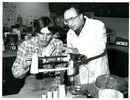 Professor and Student Working with Scale (Part of the NMU Historic Photographs Collection)