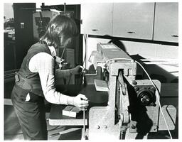 Student Using Industrial-Strength Paper Cutter (Part of the NMU Historic Photographs Collection)