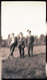 Three Blurry Men in Field