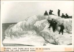 Several Lake Shore Boys Play on an Iceberg along the Lake Superior Shore