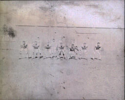 Football ca. 1960: Blurry Photo of Players Posed Ready to Make A Play