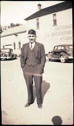 (008-031) Man in Military Hat in front of Ontonagon Cooperative Store