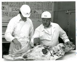 Two Men Butchering Large Piece of Meat (Part of the NMU Historic Photographs Collection)