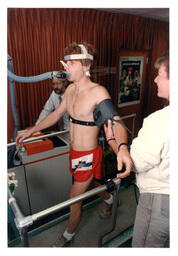 Side View of Test Subject Walking on Treadmill while Researchers Look On (Part of the NMU Historic Photographs Collection)