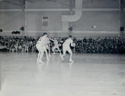 (128-03) Basketball NMC vs. Michigan Tech Feb. 24, 1960: Michigan Tech Player Dribbling