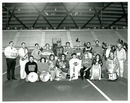 Marching Band Alumni Posing with Instruments in Superior Dome (Part of the NMU Historic Photographs Collection)