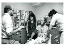 Man Getting His Vitals Checked by Multiple People (Part of the NMU Historic Photographs Collection)