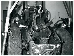 Two Students Lifting Engine Block of Tractor (Part of the NMU Historic Photographs Collection)