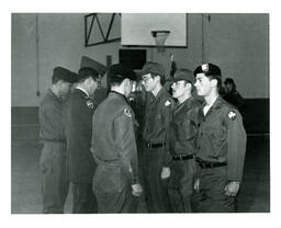 Men in Military Uniforms Facing Each Other in Two Lines on Basketball Court (Part of the NMU Historic Photographs Collection)