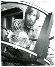 Student Looks at Sphere in Machine (Part of the NMU Historic Photographs Collection)