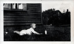 Baby on Blanket Reaching for Bottle