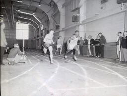 (596-02) Track--NMC vs. Marquette Feb. 11, 1961: Three Men Running on Track at Track Meet