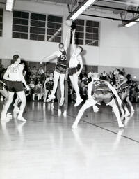 Basketball--NMC vs. Michigan Tech at Michigan Tech Feb. 22, 1961: Two Basketball Players Reaching for Ball During Game