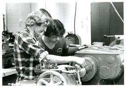 Two Students Looking at Machine (Part of the NMU Historic Photographs Collection)