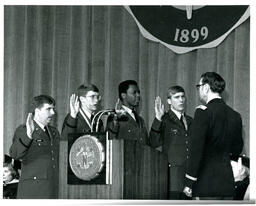 Four Men Taking Oath on Stage at Graduation (Part of the NMU Historic Photographs Collection)