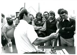 Group of People Watching a Man Demonstrate a Torch (Part of the NMU Historic Photographs Collection)