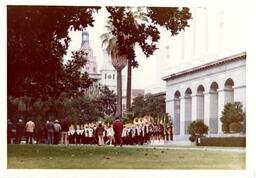 Marching Band Performing near Palm Trees and Large Buildings (Part of the NMU Historic Photographs Collection)