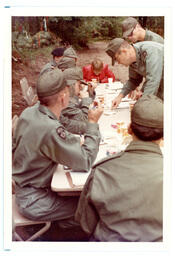 ROTC Students and One Civilian Gathered around Table Outside  (Part of the NMU Historic Photographs Collection)