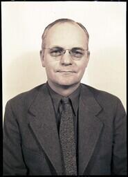 (028-011) Photograph of a Man in a Suit with Tinted Glasses