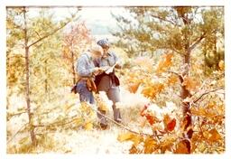 Two Competitors Looking at Papers in the Woods (Part of the NMU Historic Photographs Collection)