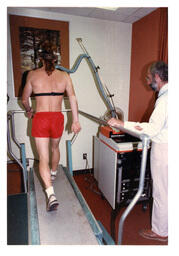 Back View of Test Subject Walking on Treadmill while Researchers Look On (Part of the NMU Historic Photographs Collection)