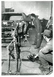 Two Mechanics Students Changing Frame of Car (Part of the NMU Historic Photographs Collection)