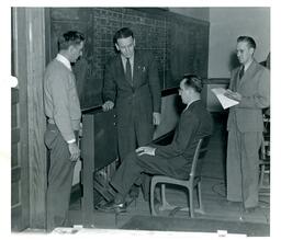 Man Using Pedal Training Machine while Other Men Watch (Part of the NMU Historic Photographs Collection)