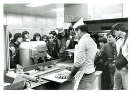 Children Watching Man Cut Up Pastry (Part of the NMU Historic Photographs Collection)