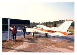 People Looking at Small Plane (Part of the NMU Historic Photographs Collection)