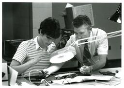 Professor Demonstrating Soldering for Student (Part of the NMU Historic Photographs Collection)